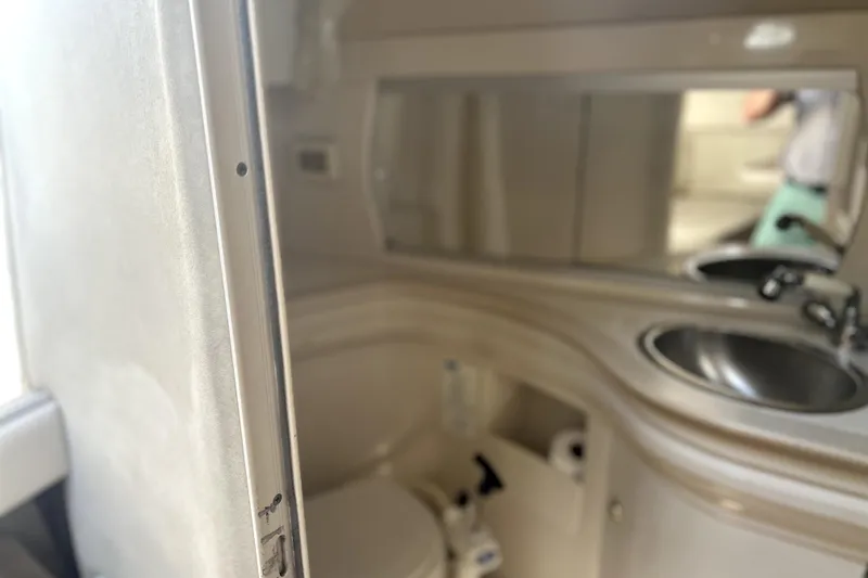 Slide: The Image of Bathroom interior of 2001 Regal Commodore 2960 boat, featuring sink and mirror. - 18