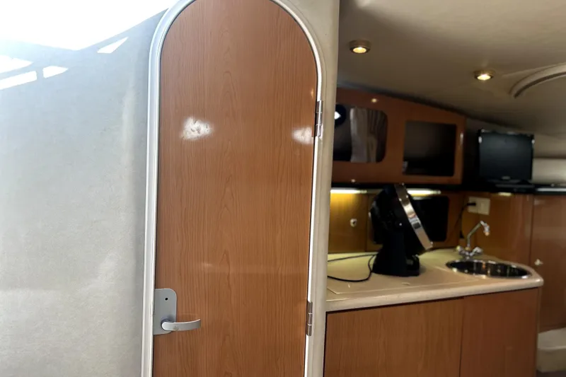 Slide: The Image of Interior of 2001 Regal Commodore 2960 boat with kitchenette and wooden door. - 19