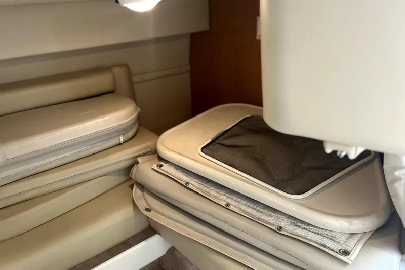 Slide: The Image of Interior cabin of 2001 Regal Commodore 2960 with beige cushions and storage compartments. - 21