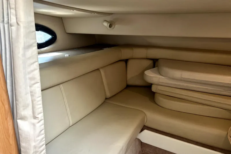 Slide: The Image of 2001 Regal Commodore 2960 cabin interior with beige seating and cushions. - 22