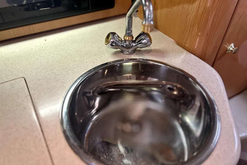 Slide: The Image of 2001 Regal Commodore 2960 boat interior with stainless steel sink and faucet. - 23