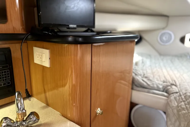 Slide: The Image of Interior of 2001 Regal Commodore 2960 boat with wood cabinetry and cozy sleeping area. - 32