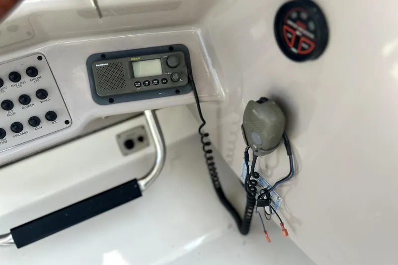 Slide: The Image of Control panel of a 2001 Regal Commodore 2960 boat with radio and switches. - 33