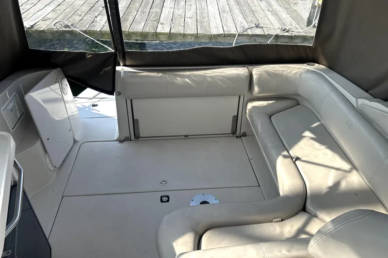 Slide: The Image of 2001 Regal Commodore 2960 boat interior with beige seating and dock view. - 4