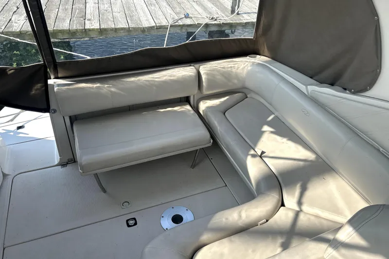 Slide: The Image of 2001 Regal Commodore 2960 boat interior with beige leather seating and dock view. - 7