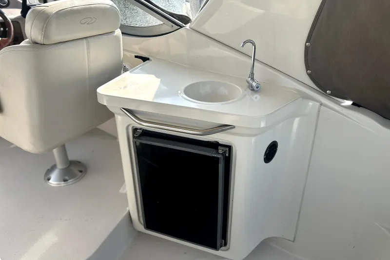 Slide: The Image of 2001 Regal Commodore 2960 boat interior with sink and mini fridge. - 8