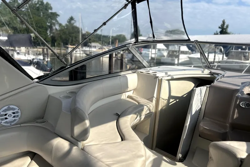 Slide: The Image of 2001 Regal Commodore 2960 boat interior with beige seating and marina view. - 9