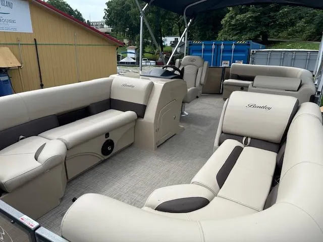 Slide: The Image of 2025 Bentley Pontoons 220 Cruise XL interior with luxurious seating and helm station. - 1