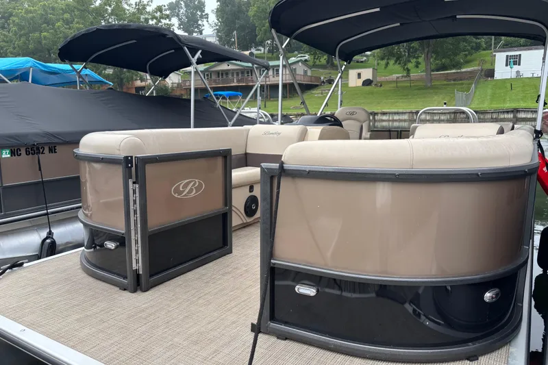 Slide: The Image of 2025 Bentley Pontoons 220 Cruise XL, luxury pontoon boat with spacious seating and canopy. - 5