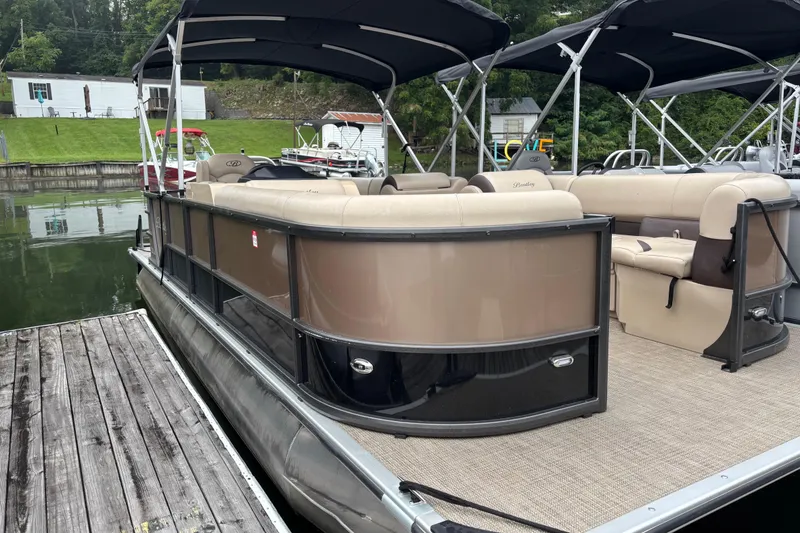 Slide: The Image of 2025 Bentley Pontoons 220 Cruise XL docked, featuring spacious seating and elegant design. - 6