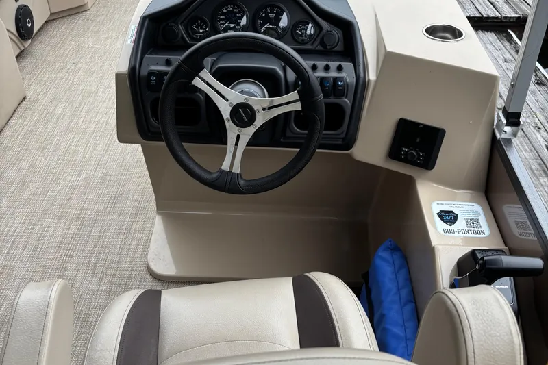 Slide: The Image of 2025 Bentley Pontoons 220 Cruise XL steering console with gauges and controls. - 9