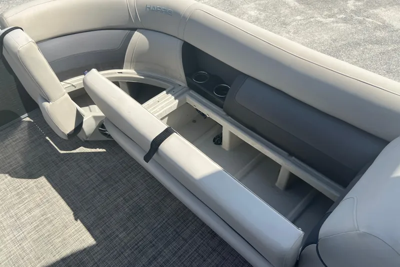 Slide: The Image of 2023 Harris Cruiser 230 boat interior with seating and storage compartment. - 10