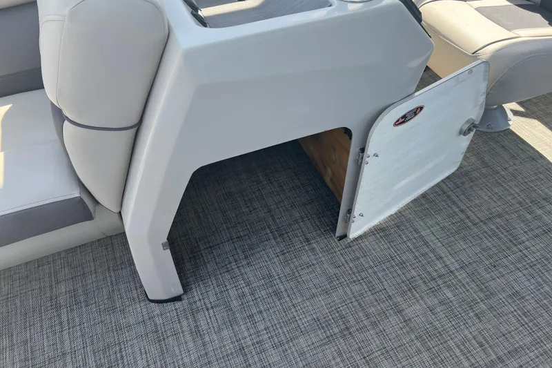 Slide: The Image of 2023 Harris Cruiser 230 boat dashboard with steering wheel and control panel. - 12