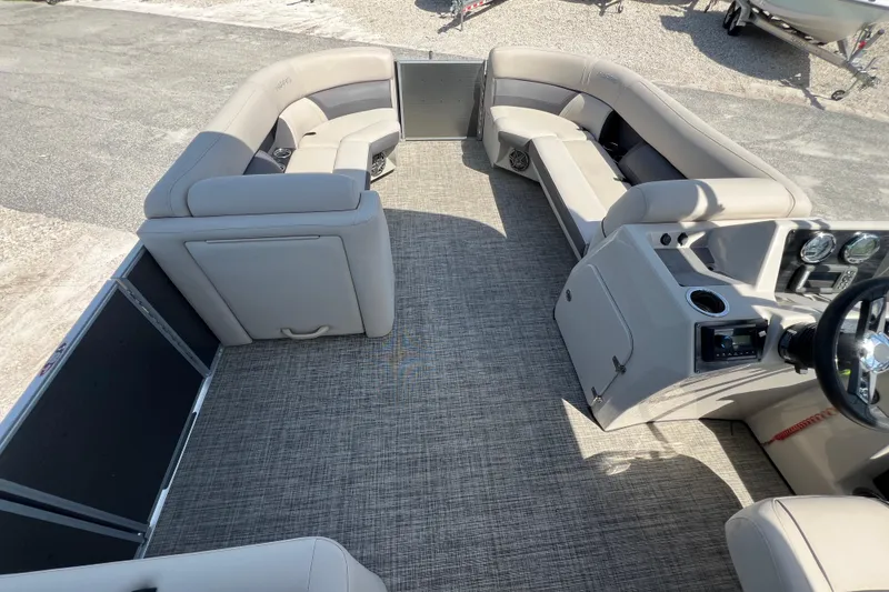 Slide: The Image of 2023 Harris Cruiser 230 boat interior with beige seating and metal railing detail. - 17