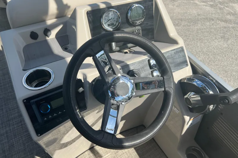 Slide: The Image of 2023 Harris Cruiser 230 pontoon boat on trailer, parked outdoors. - 21