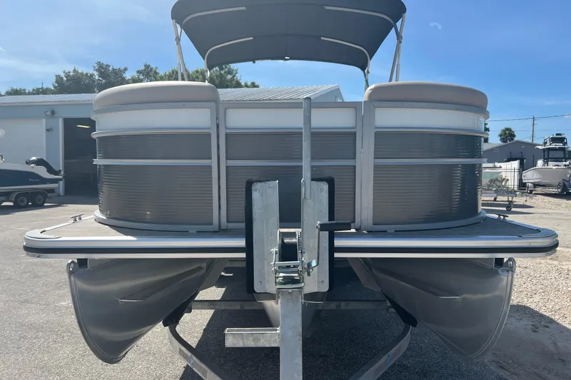 Slide: The Image of 2023 Harris Cruiser 230 pontoon boat interior with plush seating and steering console. - 3