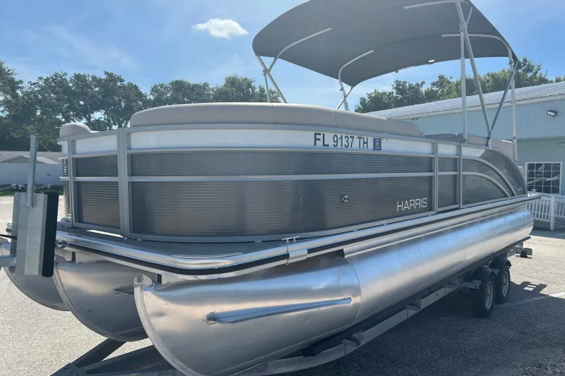 Slide: The Image of 2023 Harris Cruiser 230 pontoon boat interior with spacious seating and modern helm. - 4