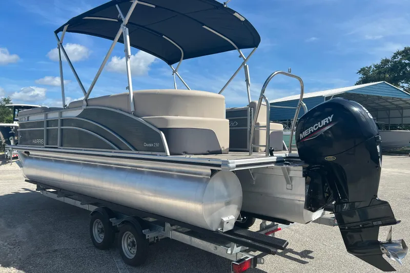 Slide: The Image of 2023 Harris Cruiser 230 boat interior with gray seating and cup holders. - 5