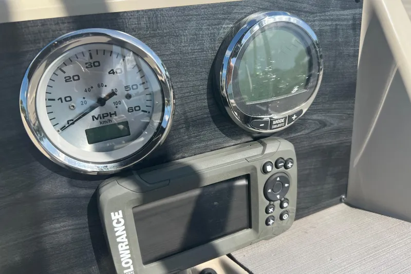 Slide: The Image of 2023 Harris Cruiser 230 boat console with cup holders and USB port. - 8