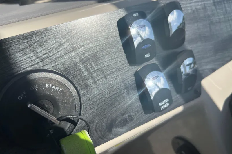 Slide: The Image of 2023 Harris Cruiser 230 boat with outboard motor and stainless steel railing. - 9