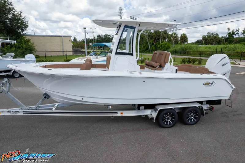 Slide: The Image of 2025 Sea Hunt Ultra 235 SE boat on trailer, white exterior, brown seating, outdoor setting. - 10