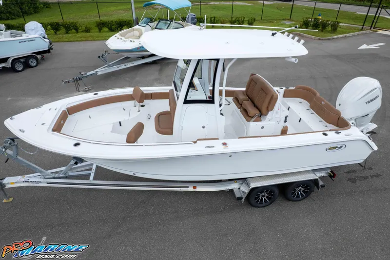Slide: The Image of 2025 Sea Hunt Ultra 235 SE boat on trailer, featuring sleek design and spacious seating. - 11