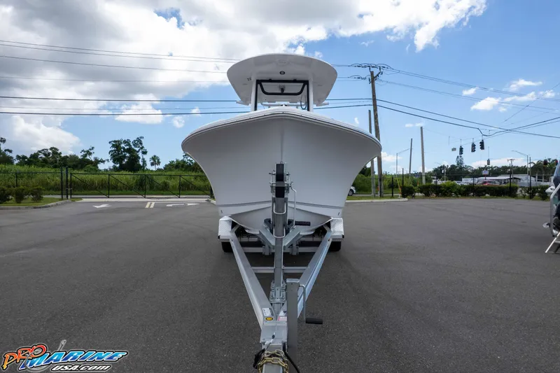 Slide: The Image of 2025 Sea Hunt Ultra 235 SE boat on trailer, parked outdoors under a cloudy sky. - 12