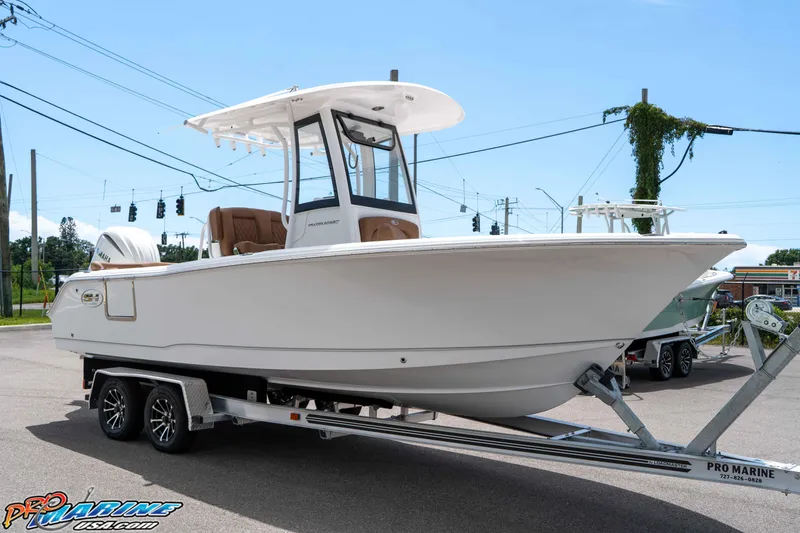 Slide: The Image of 2025 Sea Hunt Ultra 235 SE boat on trailer, displayed outdoors. - 17
