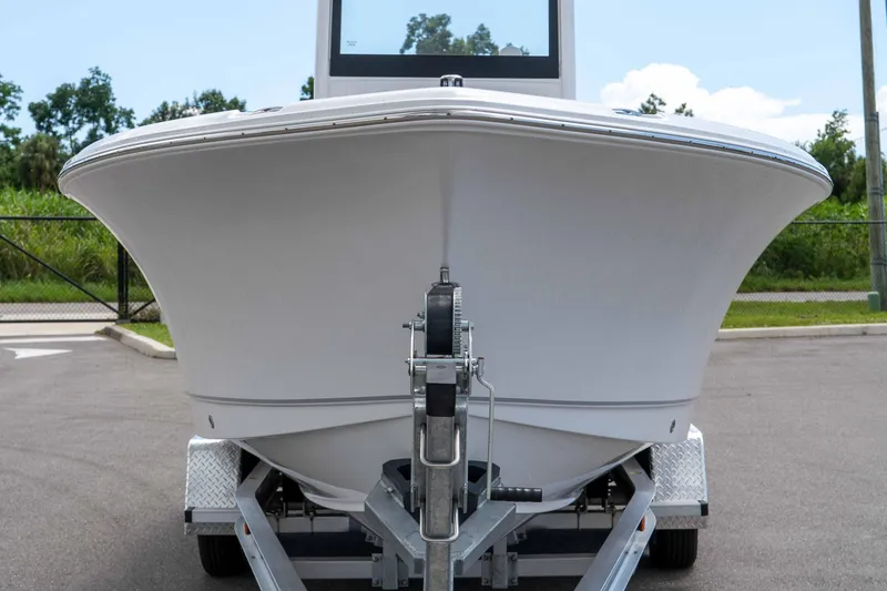 Slide: The Image of 2025 Sea Hunt Ultra 235 SE boat on trailer, front view, outdoors. - 19