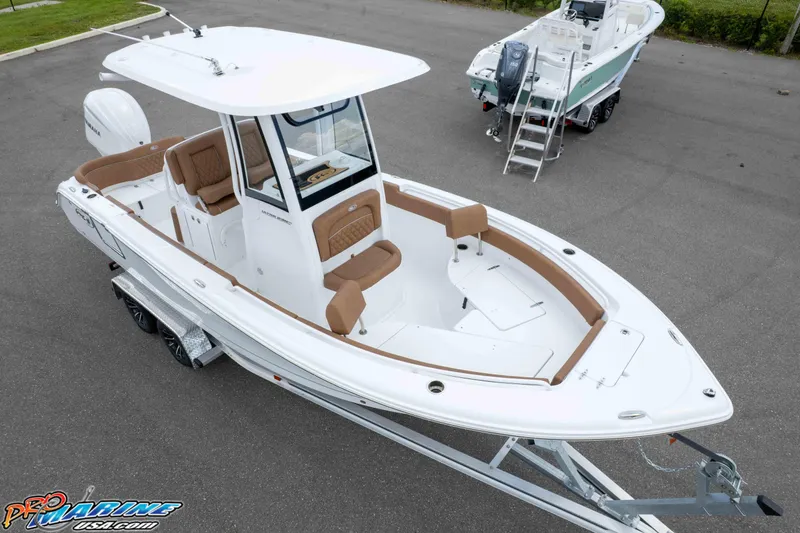 Slide: The Image of 2025 Sea Hunt Ultra 235 SE boat on trailer, featuring sleek design and spacious seating. - 2