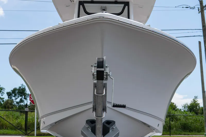 Slide: The Image of 2025 Sea Hunt Ultra 235 SE boat front view, showcasing sleek hull design. - 20