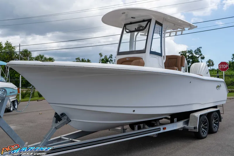 Slide: The Image of 2025 Sea Hunt Ultra 235 SE boat on trailer, parked outdoors. - 21