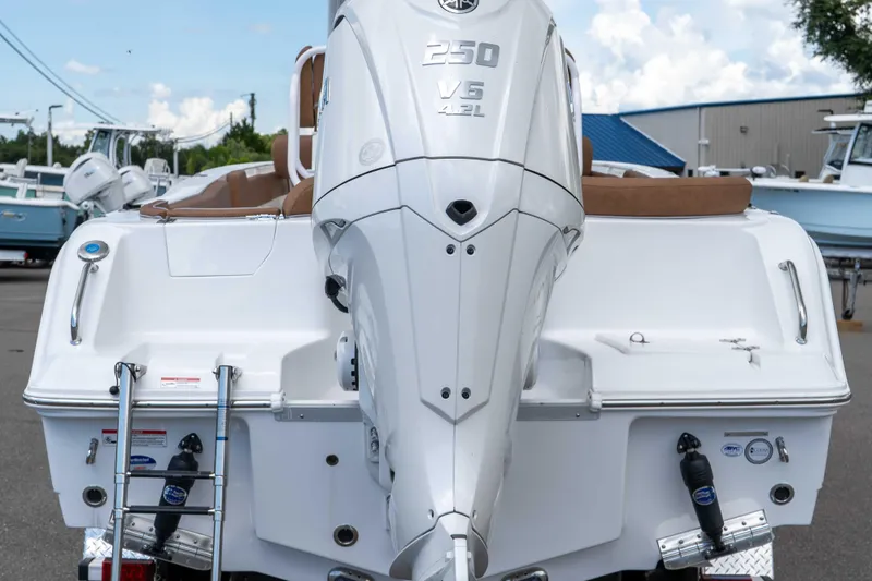 Slide: The Image of 2025 Sea Hunt Ultra 235 SE boat with powerful 250 V6 engine, docked outdoors. - 27