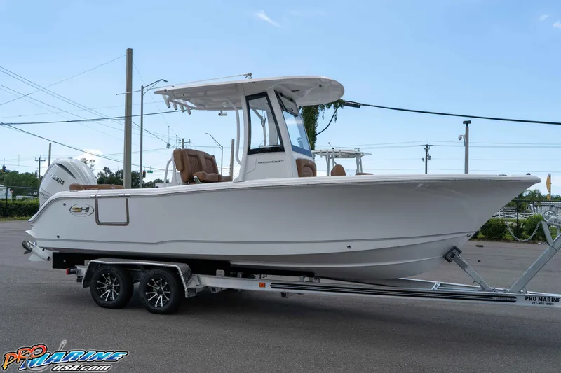 Slide: The Image of 2025 Sea Hunt Ultra 235 SE boat on trailer, side view, outdoors. - 29