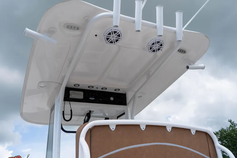 Slide: The Image of 2025 Sea Hunt Ultra 235 SE boat's T-top with rod holders and speakers. - 33