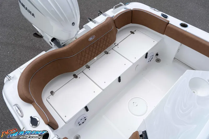 Slide: The Image of 2025 Sea Hunt Ultra 235 SE boat interior with brown seating and Yamaha engine. - 34