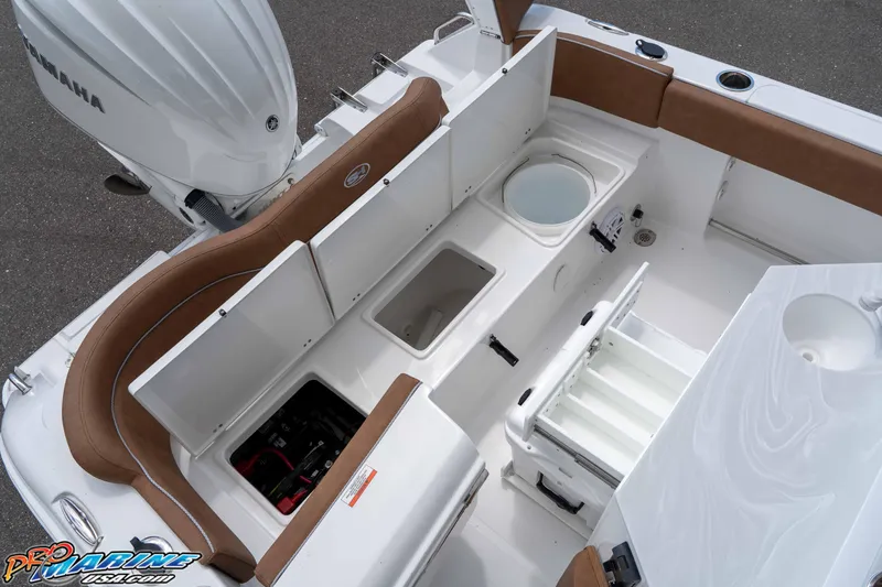 Slide: The Image of 2025 Sea Hunt Ultra 235 SE boat interior with storage compartments and Yamaha engine. - 35