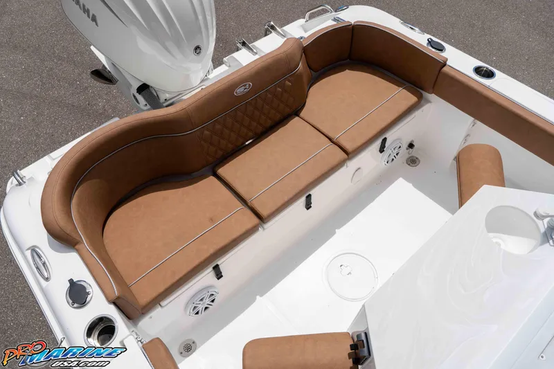 Slide: The Image of 2025 Sea Hunt Ultra 235 SE boat interior with brown cushioned seating and Yamaha engine. - 36