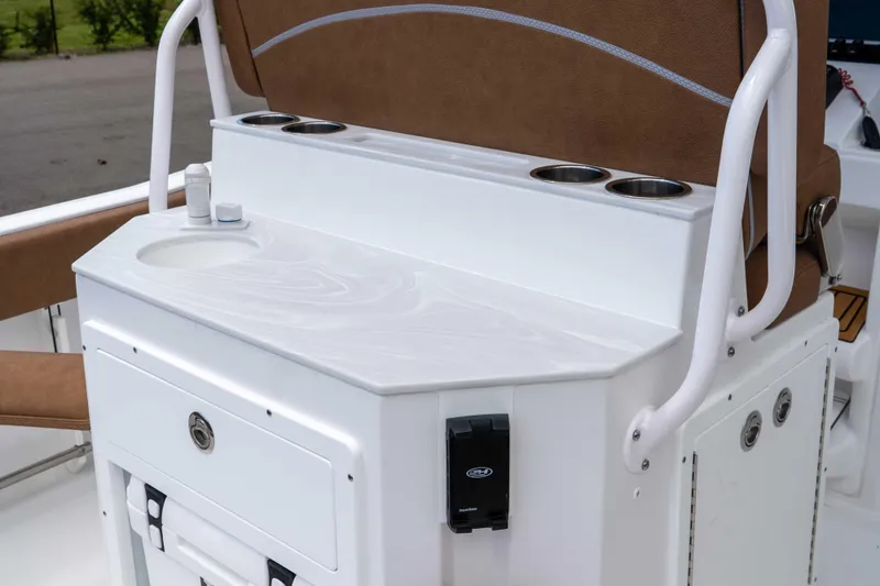 Slide: The Image of 2025 Sea Hunt Ultra 235 SE boat console with sink and cup holders. - 37