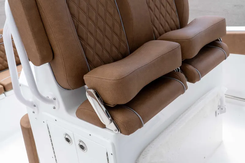 Slide: The Image of 2025 Sea Hunt Ultra 235 SE boat seats with brown leather upholstery and diamond stitching. - 42