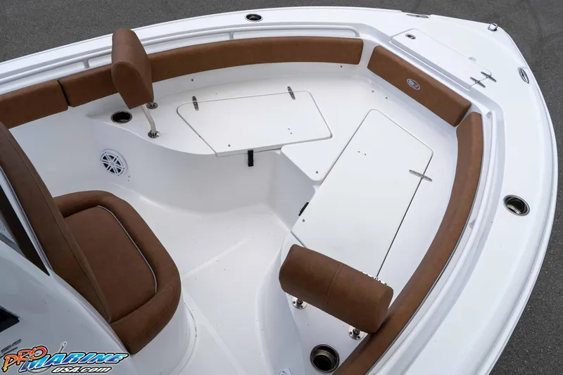 Slide: The Image of 2025 Sea Hunt Ultra 235 SE boat interior with brown seating and storage compartments. - 44