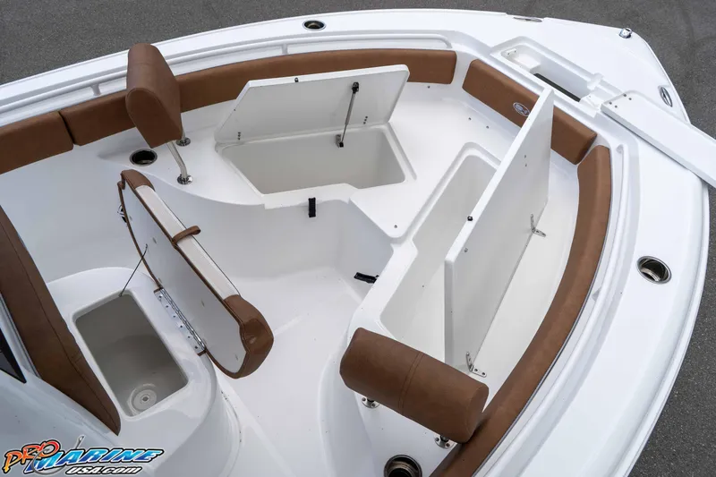 Slide: The Image of 2025 Sea Hunt Ultra 235 SE boat interior with open storage compartments and brown seating. - 45