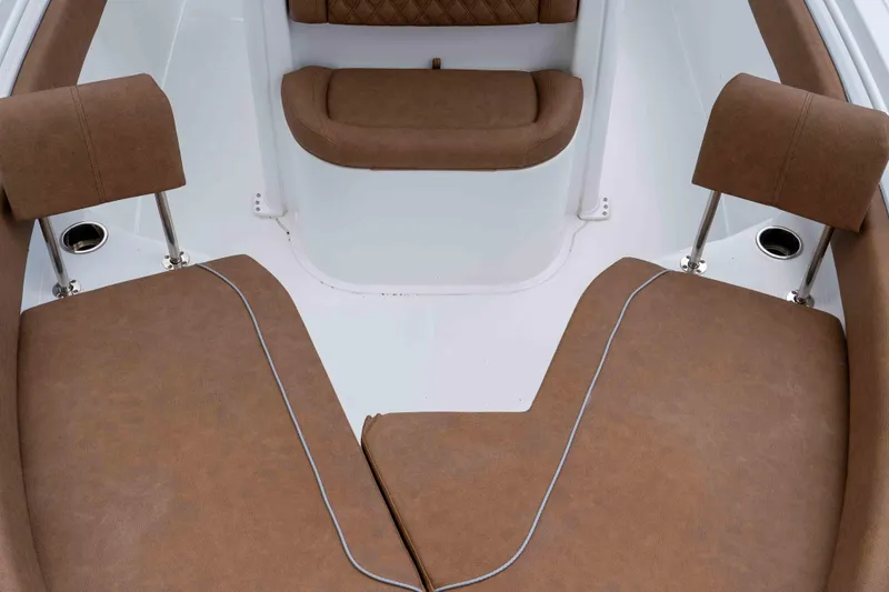 Slide: The Image of 2025 Sea Hunt Ultra 235 SE boat interior with brown cushioned seating. - 47
