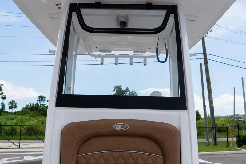 Slide: The Image of 2025 Sea Hunt Ultra 235 SE boat console with brown cushioned seating. - 48