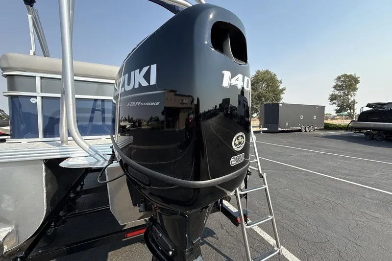 Slide: The Image of 2026 Landau Island Breeze 21 C with Suzuki 140 outboard motor in parking lot. - 18