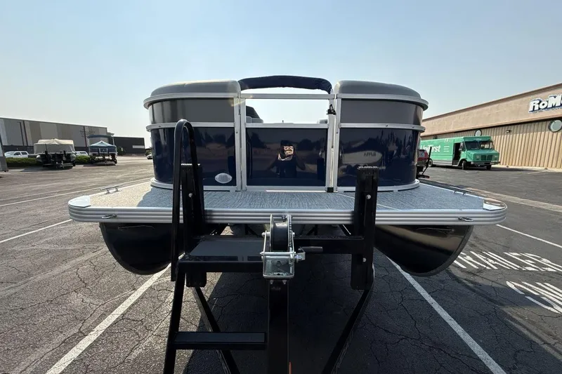 Slide: The Image of 2026 Landau Island Breeze 21 C pontoon boat in parking lot, rear view. - 8