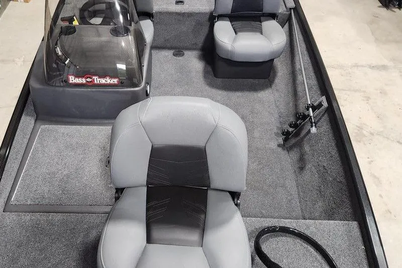 Slide: The Image of 2026 Tracker BASS TRACKER® Classic XL boat interior with gray seating and steering console. - 8