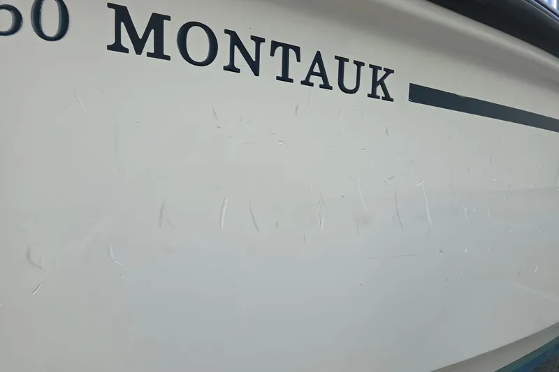 Slide: The Image of 2022 Boston Whaler 150 Montauk boat hull with visible scratches. - 13