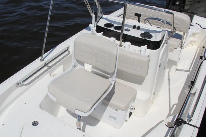 Slide: The Image of 2022 Boston Whaler 150 Montauk boat interior with seating and console. - 18