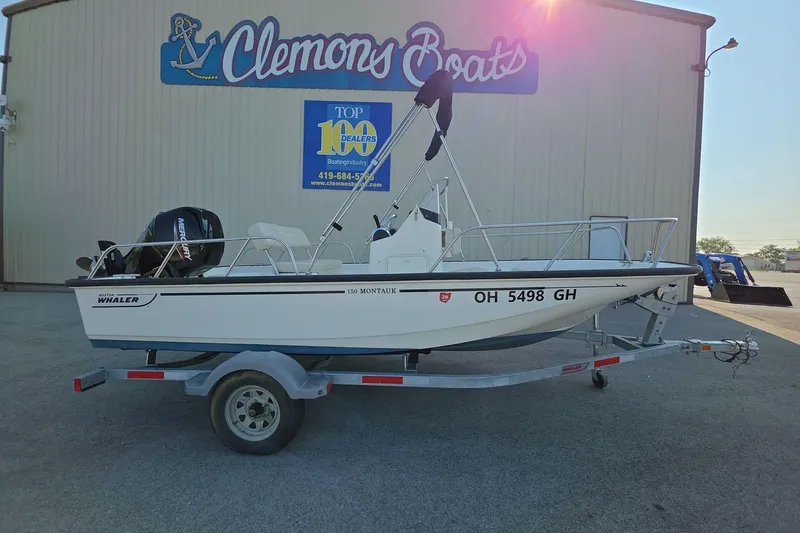 Slide: The Image of 2022 Boston Whaler 150 Montauk boat on trailer at Clemons Boats dealership. - 2